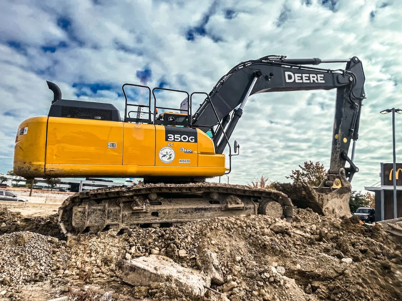 Excavator working a dirt pile on a Southwest Iron & Excavation job site